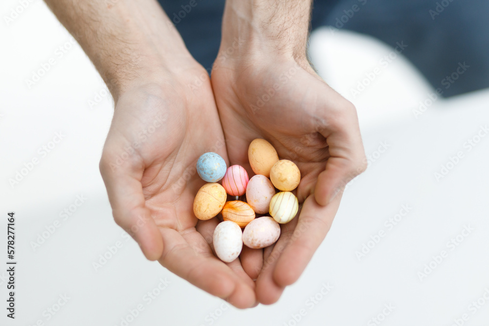 Easter toys. Easter toys in the hands of a man. Blurred background. Easter holiday concept background. Easter toys. Easter toys in the hands of a man. Blurred background. Easter holiday concept background.