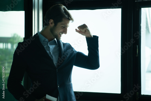 Businessman with emotions while waiting for a long journey at the airport terminal photo