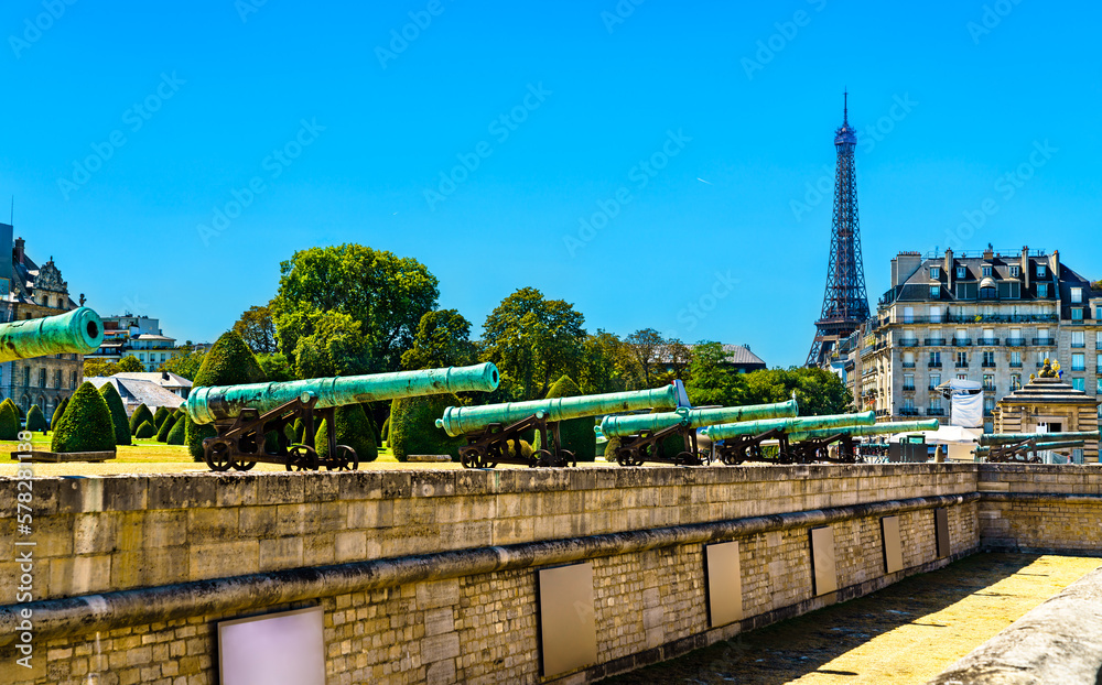 Historic cannons at les Invalides with Eiffel Tower in Paris, France