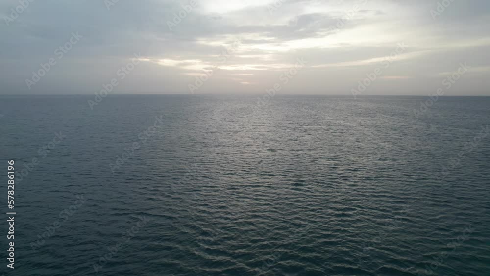 View of the clouds over the sea at sunrise. Blues mix with oranges, golden hour. View of the clouds over the sea at sunrise. Blues mix with oranges, golden hour.