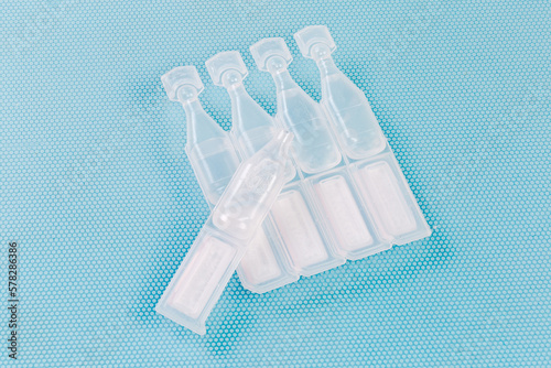 Eye drops in small disposable plastic ampoules, one open ampoule photo