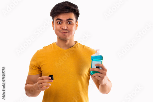 Young man rinsing mouth with mouthwash