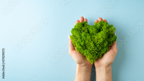 World earth day concept with green plant heart on blue background,