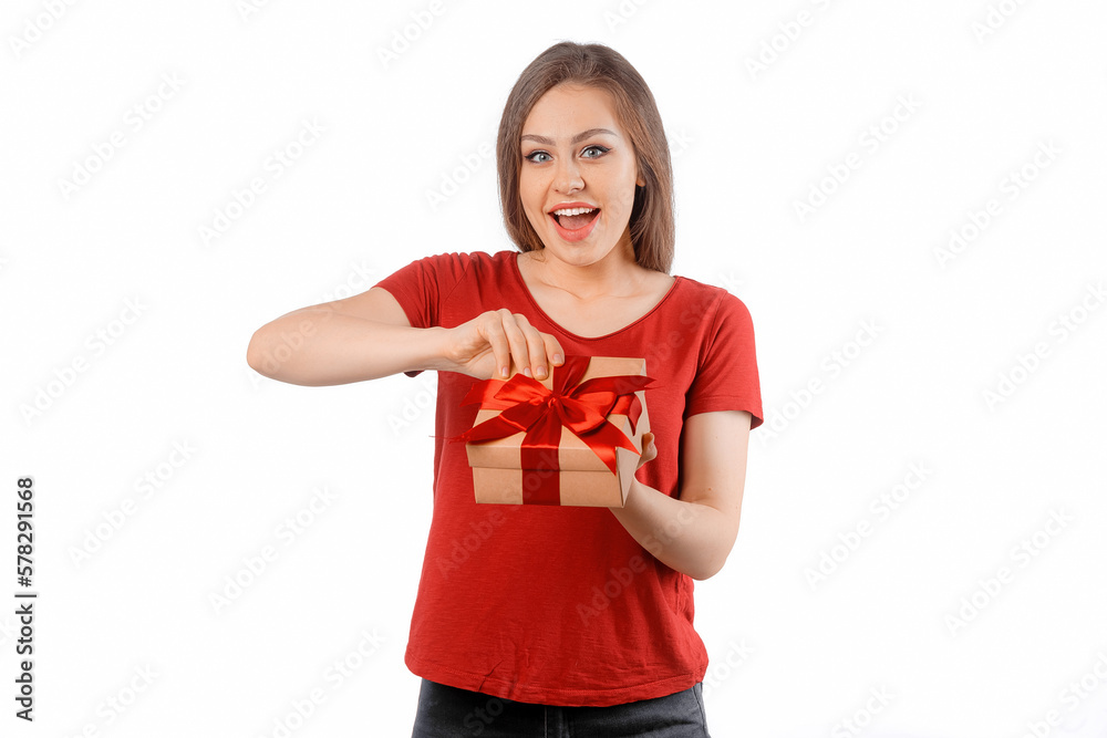 Portrait of a happy smiling girl opening a gift box and posing over white background. International Women's Day, New Year, Christmas, Birthday and Valentine's Day concept celebration Portrait of a happy smiling girl opening a gift box and posing over white background. International Women's Day, New Year, Christmas, Birthday and Valentine's Day concept celebration