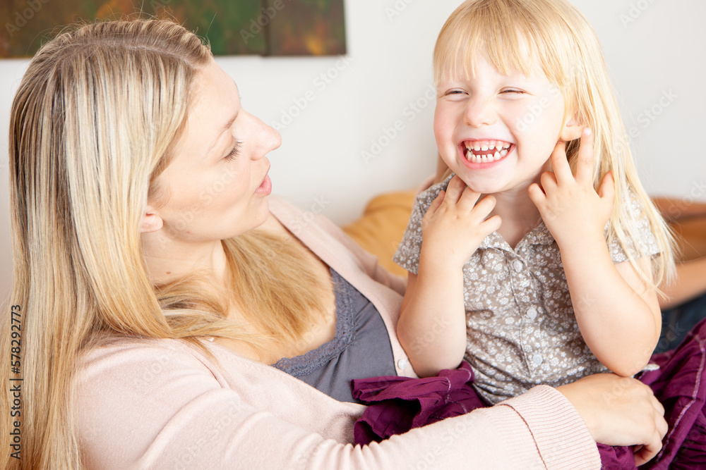 Family Life, Mother and Daughter. A candid and carefree moment between a young mother and her excited daughter. From a series of related images.
