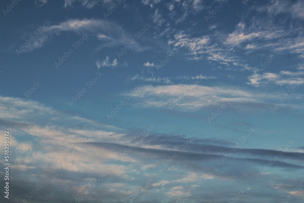 Obraz premium White light soft clouds floating in blue sky. Nature morning landscape background. Clear spring wind. Bright summer day. Winter calm air skyscape. Abstract panorama. Change climate. Low angle view