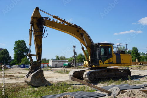 Yellow excavator on construction site