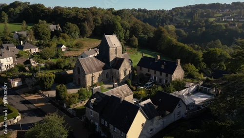 Saint-Hilaire church in rural landscape, Neufbourg, Mortain in France. Aerial orbiting photo