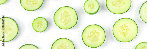Fresh cucumber slices on a white background panorama, shot from the top. Healthy organic food panoramic banner