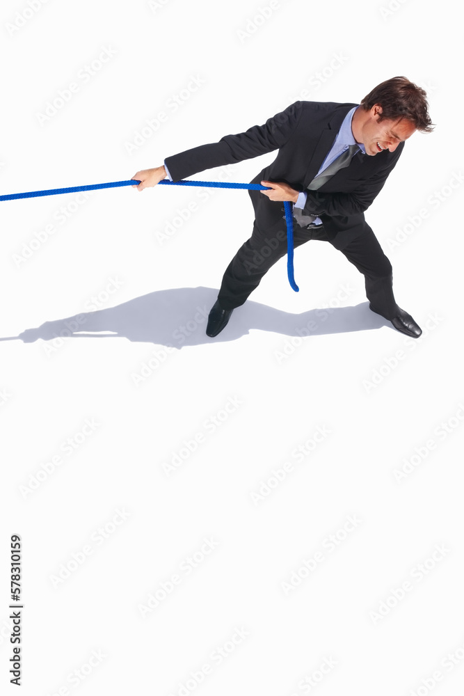 Top view of young business man pulling a rope on white. Top view of young business man pulling a rope on white background. Top view of young business man pulling a rope on white. Top view of young business man pulling a rope on white background.