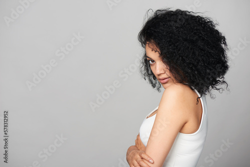 Mixed race girl looking at camera over shoulder