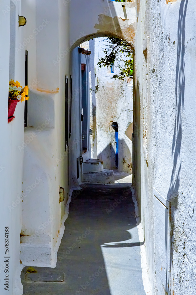 In the narrow streets of Emporio village, Santorini, Greece. The winding pathways in Kasteli, the castle are very narrow with steep stairs and very narrow doors and windows.
