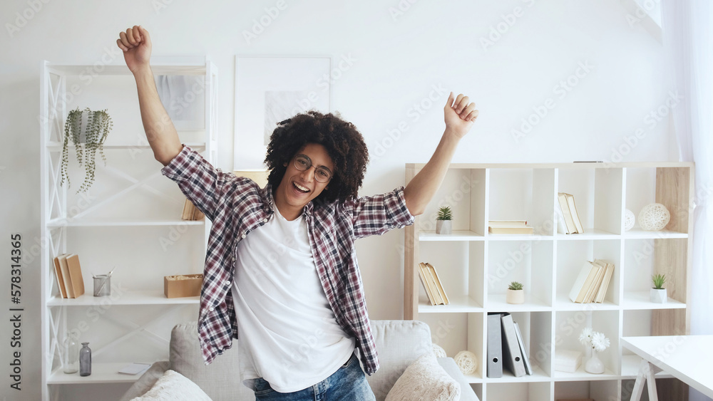 Home fun. Weekend joy. Positive lifestyle. Happy excited guy enjoying dancing alone in light morning living room with free space. Home fun. Weekend joy. Positive lifestyle. Happy excited guy enjoying dancing alone in light morning living room with free space.