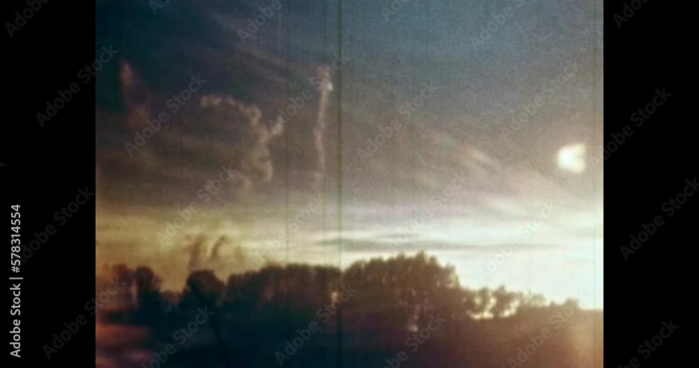 Signal flare takes off in blue sky. Flare emergency marine signals. Petersburg 1980s Russia. Signal sos explodes in cloudy sky. Help light. Vintage, archival color film. Retro archive. Old archives