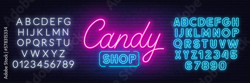 Candy Shop neon sign on brick wall background.