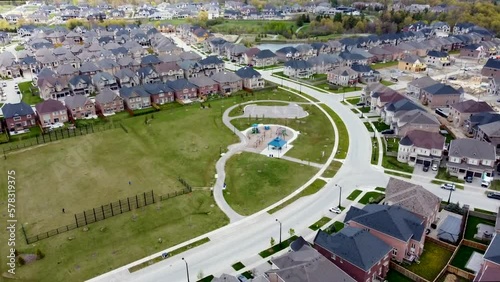 Drone flying towards a Kleinburg neighborhood park and playground in spring. photo