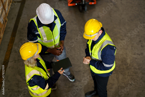 Fotografie Diversity ethnicity of warehouse staff or engineer making a discussion together before start working
