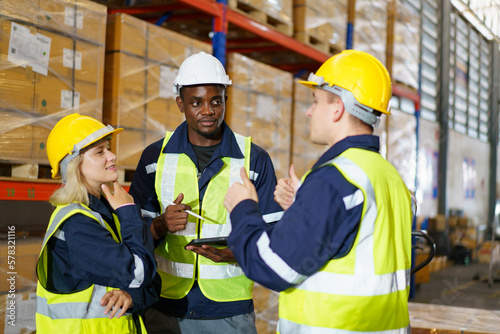 Diversity ethnicity of warehouse staff or engineer making a discussion together before start working.