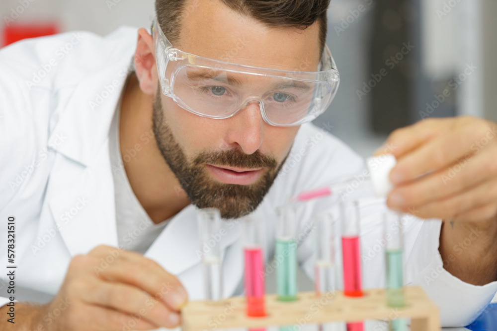 man using pipette in lab man using pipette in lab