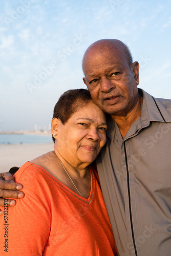 Senior couple standing at the beach together hugging © sashapritchard