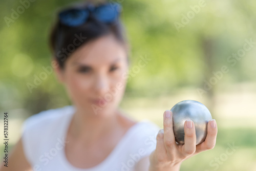 hand of woman holding petanque ball or boule