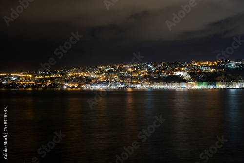 Naples, Italy promenade and city night view. Mergellina coastal section seen from the waterfront at the gulf of Napoli.