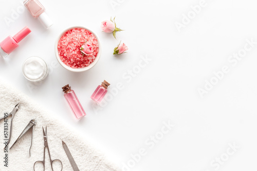 Pink roses flowers and manicure tools. Beauty nail care spa salon.