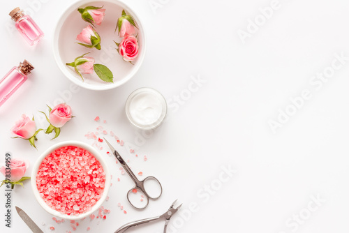 Pink roses flowers and manicure tools. Beauty nail care spa salon.