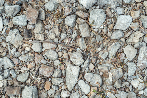 Background with stones scattered on the ground and small natural debris. Natural countryside background.