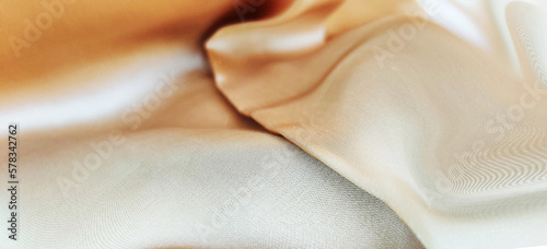 Luxurious smooth gold silk fabric design, silk fabric texture background element, luxurious shiny and smooth silk and satin cloth texture background. 