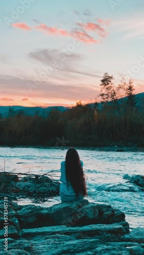 The girl spends time on the river bank