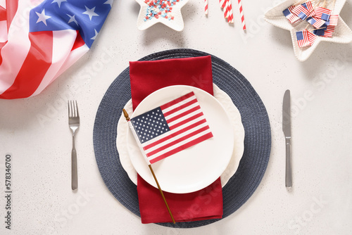 Patriotic table setting with american flag and decoration in national flag colors on white background. Independence Day. Happy Memorial Day. Top view.