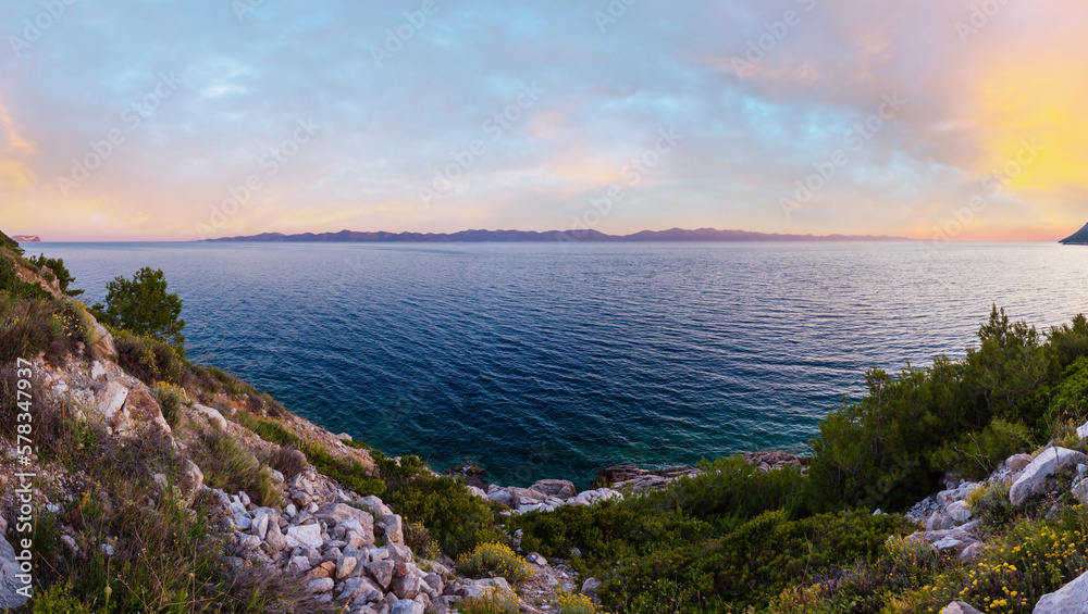 Evening summer coastline view with pink sunset and Island on horizon (Ston,  Peljesac  peninsula, Croatia)