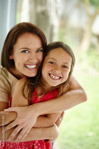 She cherishes her little girl. Portrait of a mother embracing her daughter at home.