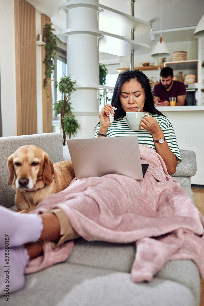 Young couple shopping online with credit card at home for Christmas Young couple shopping online with credit card at home for Christmas