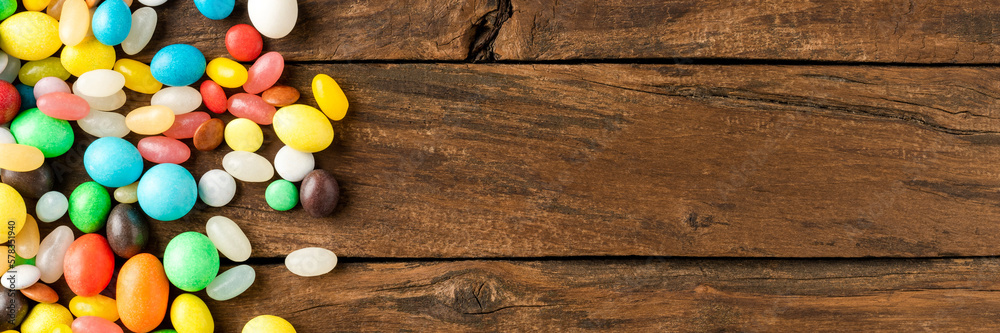 Mixed colourful candies on wooden background with copyspace Mixed colourful candies on wooden background with copyspace