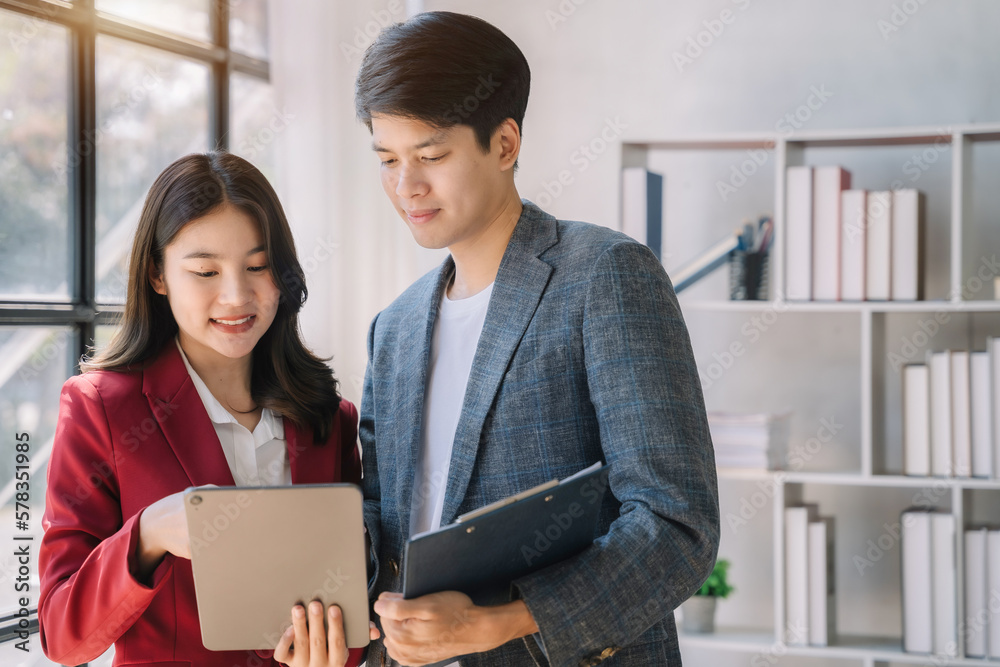 Working on finances together, young asian business couple working on finances at home office. Working on finances together, young asian business couple working on finances at home office.