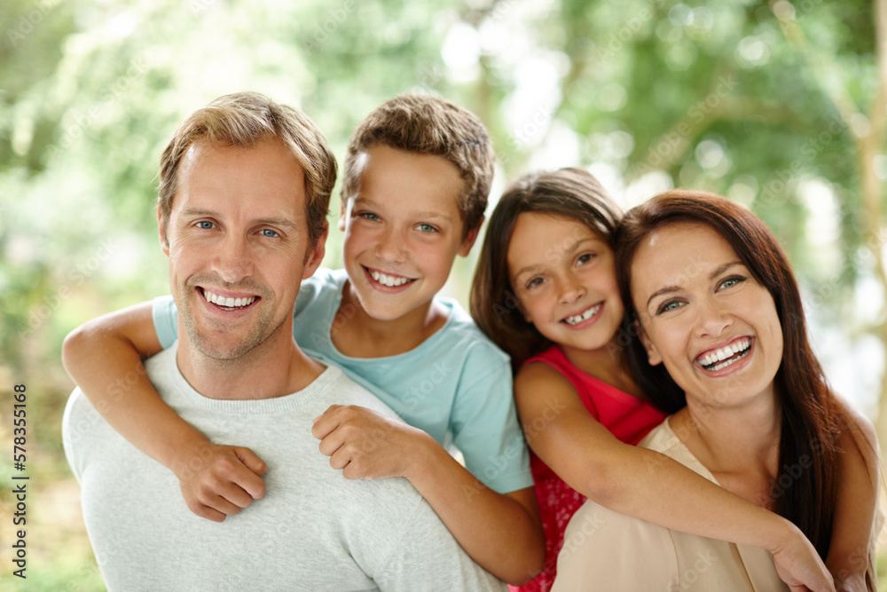 Theyre a close-knit family. Portrait of a happy family of four spending time together outdoors. Theyre a close-knit family. Portrait of a happy family of four spending time together outdoors.