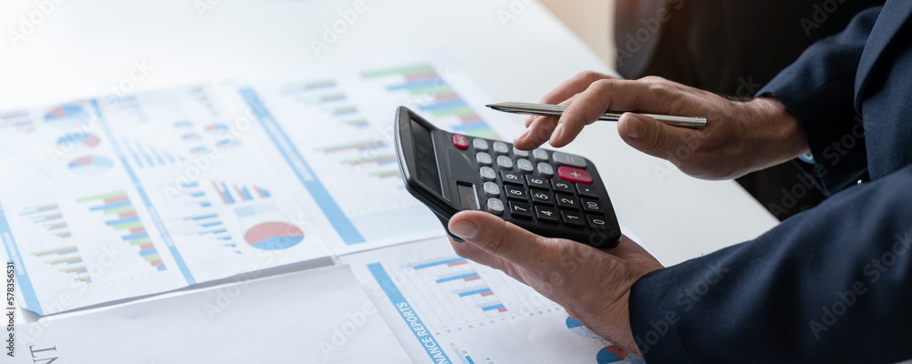 A group of Asian businessmen are brainstorming to analyze financial reporting situations. Calculate your investments with this calculator, income, tax and accounting from data graphs at your desk. A group of Asian businessmen are brainstorming to analyze financial reporting situations. Calculate your investments with this calculator, income, tax and accounting from data graphs at your desk.