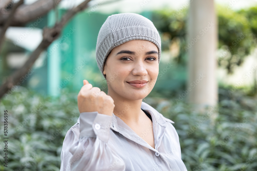 Strong recovered south asian Indian woman cancer patient wearing head