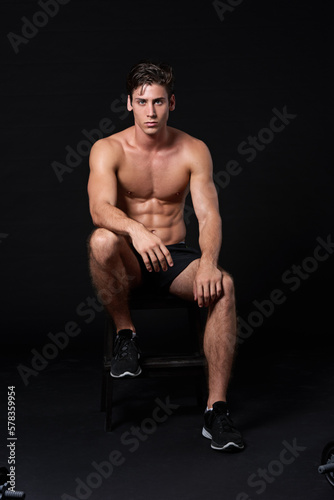 Built to last. Studio shot of a muscular bare-chested young man isolated on black.