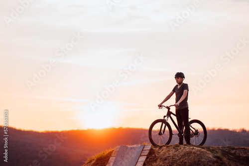 silhouette of a mountain biker at sunset © kerkezz