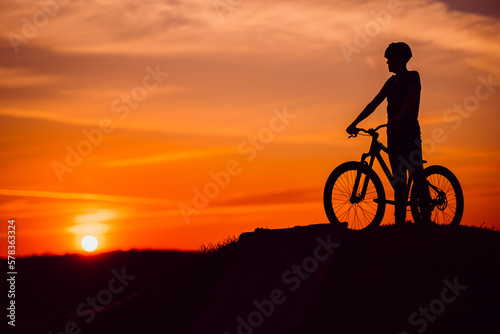 Fototapeta Naklejka Na Ścianę i Meble -  silhouette of a mountain biker at sunset