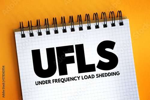 UFLS - Under Frequency Load Shedding acronym text on notepad, abbreviation concept background photo