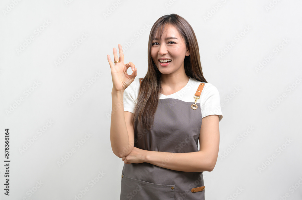 Portrait of young asian woman wearing apron over white background studio, cooking and entrepreneur concept. Portrait of young asian woman wearing apron over white background studio, cooking and entrepreneur concept.