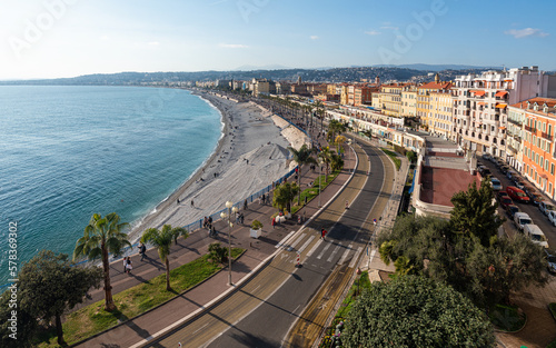 Beautiful panorama of Nice from Colline du Chateau. Pebble beach, Promenade des Anglais and old Nice colorful architecture cityscape.