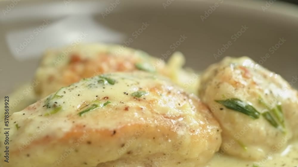 The chef sprinkles with black pepper the freshly prepared creamy chicken with tarragon.
The chef sprinkles with black pepper the freshly prepared creamy chicken with tarragon.