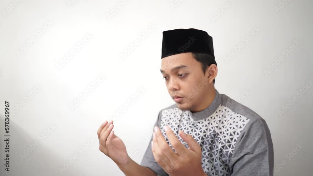 Indonesia Asian muslim men praying gesture wears black peci or songkok