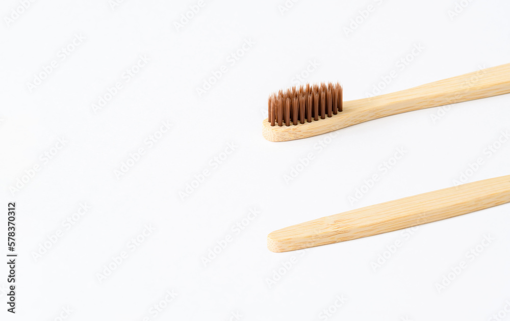 Wooden toothbrush on a light background. Zero waste concept. Everyday eco-friendly items made from biodegradable materials. copyspace. Wooden toothbrush on a light background. Zero waste concept. Everyday eco-friendly items made from biodegradable materials. copyspace.