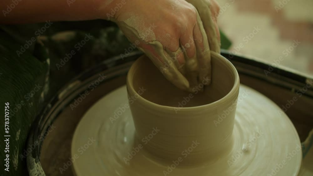 Girl works in her atmospheric craft workshop pottery studio Girl works in her atmospheric craft workshop pottery studio